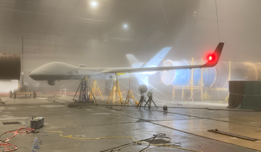 Protector aircraft being tested under a foggy environment within a hangar. 